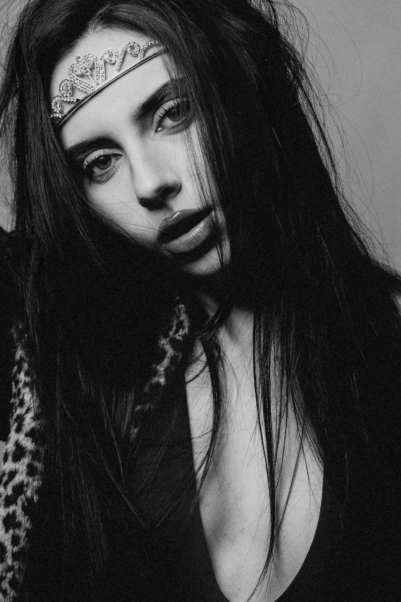 Black and white portrait of a woman with long hair and a patterned headband