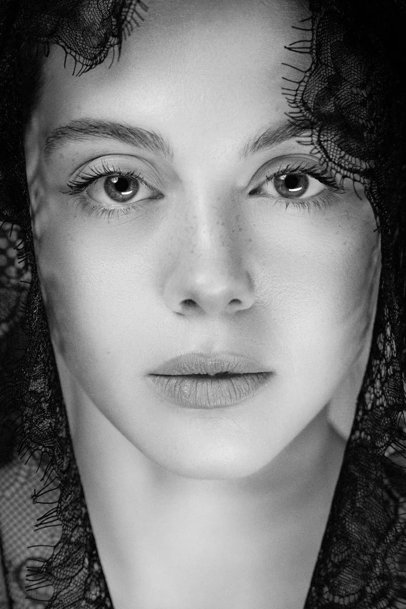 Close portrait of a woman with a lace veil over her hair