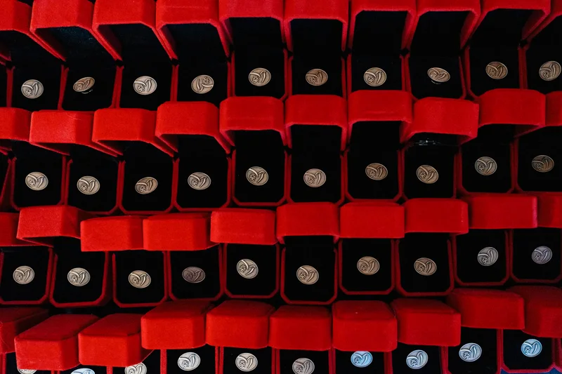 Rows of red boxes holding medals