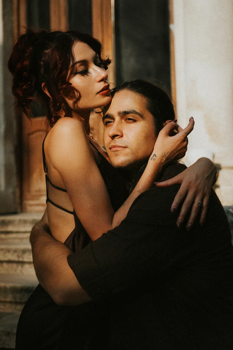 Couple embracing on the steps of an old building