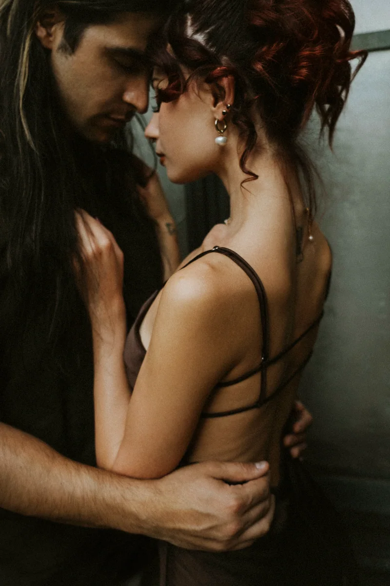 Intimate portrait of a couple, foreheads together, in warm light